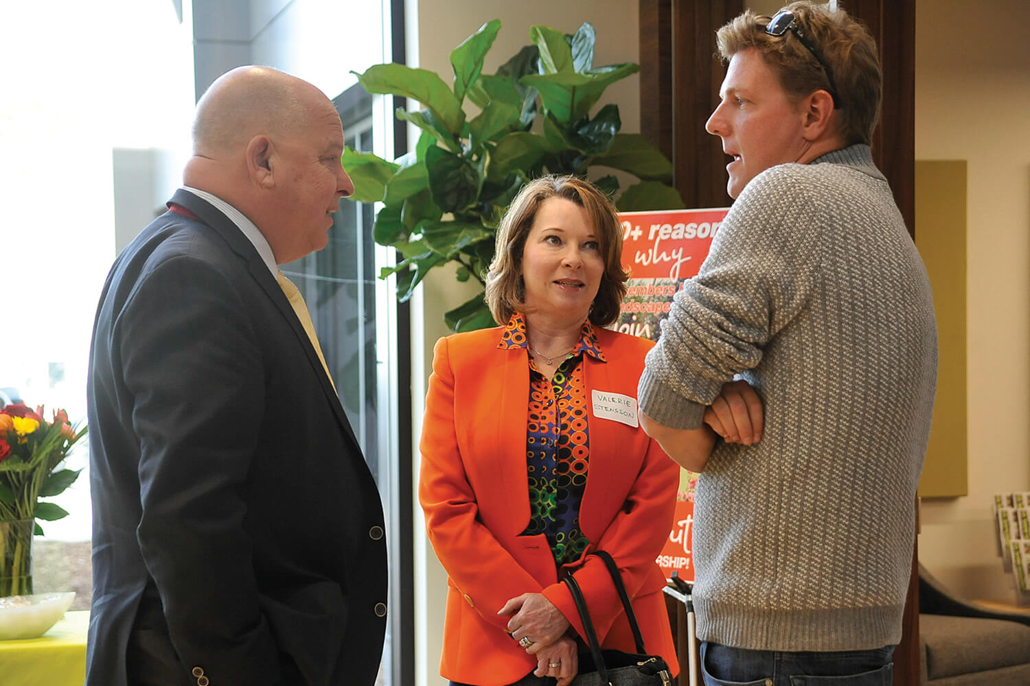 two men and a woman talking