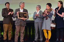 winners accepting an award on stage