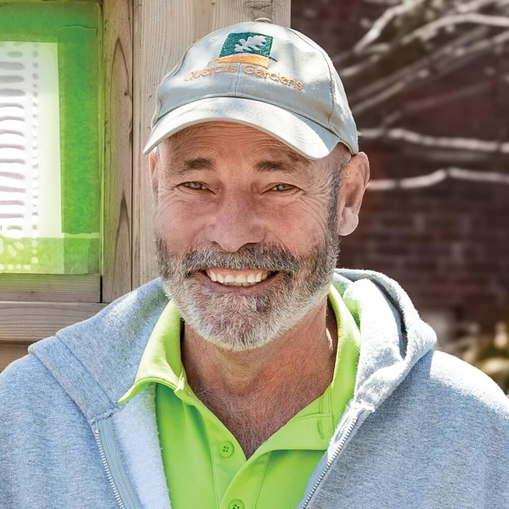 man wearing a baseball cap and smiling